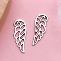 Antique silver angel wing charm for DIY jewelry making on pink background - Antique Silver Hollow Wing (B116)