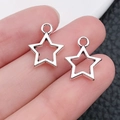 Silver hollow star charms for DIY necklaces, held in hand to show the actual small size - Hollow Star Style (1)