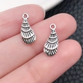 Macro shot of silver-plated shell pendants with detailed radial textures and top hanging holes - Marine Conch (17311)