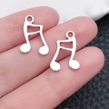 DIY silver-tone beam note charms in alloy material held on palm to show small scale - Antique Silver Note (15760)