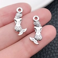 Detailed silver mermaid charm pendants for jewelry making shown in hand for scale - Marine Mermaid (8213)