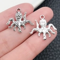 Vintage silver octopus alloy charm pendant for jewelry making shown in hand display - Marine Octopus (10357)