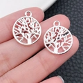 Pair of antique silver tree of life pendants held in hand for size visualization - Bright Silver Round Tree Of Life (19887)