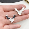 Macro detail of bat skull alloy charms with dripping oil finish and textured metal back - Enamel Bat Skull Pendant (19376)