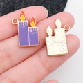 Detail of purple candle enamel charms for Halloween jewelry with golden metal backing - Purple