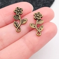 Antique bronze flower pendants held on finger to show vintage diy jewelry scale - Long Strip Flower (20483)