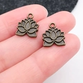 Antique bronze lotus flower pendants for DIY jewelry making held by fingers - Lotus (20488)