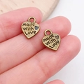 Macro shot of bronze heart charms engraved with Made With Love for DIY jewelry making - Made With Love Heart Charm (815)