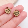 Macro shot of vintage bronze heart-shaped DIY charm pendants with Thank You engraving - Thank You Lettering Heart Charm (7025)