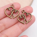 Macro detail of antique bronze double heart charms for DIY jewelry making accessories - Double Heart Charm (19938)