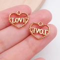 Macro shot of gold heart-shaped pendants with 'LOVE' engraving for DIY jewelry making - Hollow Love Heart (17686)