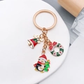Christmas keychain with gold penguin, red bell and wreath charms on white stand - Christmas Penguin Wreath Bell Style (ER819)