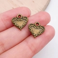 Antique bronze heart pendants with intricate scroll patterns for DIY jewelry making - Carved Heart Charm (19946)