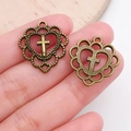 Antique bronze heart cross pendant charm for DIY jewelry making shown in hand - Cross Hollow Heart Charm (20310)