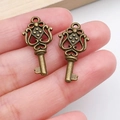 Close-up of vintage bronze alloy key pendants with intricate filigree for DIY jewelry - Vintage Hollow Key Style (20989) / Antique Bronze