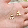 Golden and pink enamel musical note charms for DIY jewelry making held in palm - Enamel Musical Instrument Note Style (19437) / Pink