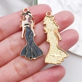 Golden alloy charm of a woman in a black dress with black enamel drip finish - Black Long Dress Model