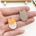 Close-up of cat in a teacup enamel charm pendant showing the gold textured back side - Orange Cat Pink Cup
