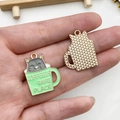 Detailed macro view of enamel cat coffee cup charms with golden mesh back for DIY jewelry - Grey Cat Green Cup