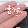 Detailed view of silver cross pendants featuring intricate filigree and heart cutouts - Heart Spliced Cross Style (20355)