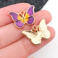 Golden butterfly pendant with purple and yellow enamel drip effect held in palm - Purple and Yellow Enamel Butterfly Wing (19106)