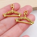 Close-up of golden metal clothes hanger charms with vintage hollowed floral patterns - Vintage Clothes Hanger (20236)