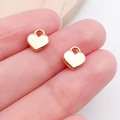 DIY rose gold heart wing pendant charms held in fingers showing small size and smooth finish - Heart Shape (19982)