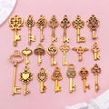 21 vintage style heart and wing skeleton key pendants for DIY jewelry on pink background - Antique Gold Key Collection (SN923)