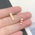 Macro shot of gold and red-white enamel lighthouse charms for DIY jewelry making - 18x5mm / Red Lighthouse