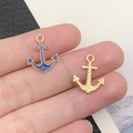 Macro shot of anchor-shaped alloy charms with blue enamel on a finger for size reference - 18x14mm / Blue Anchor Pattern