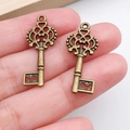 Pair of vintage antique bronze key charms with ornate filigree design for DIY jewelry - Vintage Floral Head Key Style (788) / Antique Bronze