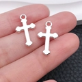 Polished silver cross pendant in alloy for DIY jewelry held in hand for size comparison - Simple Cross Style (20347)