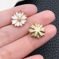 Detail showing small white enamel daisy charms for DIY jewelry on a textured background - White Enamel Daisy (19599)