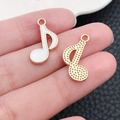 Macro view of a white enamel music note pendant with a gold textured back - White Music Note (19449)