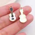 Detail view of guitar alloy pendants showing enamel finish and golden plated texture - Black White Enamel Alloy Guitar (19469)