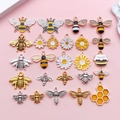 24pcs enamel bee and daisy flower alloy charms set for DIY jewelry making on pink background - Mixed Bee Series 25 Styles