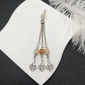 Detail view of ethnic silver tassels with carnelian beads and celtic knot pendants - Yellow Beads Antique Silver Tassel (21106)