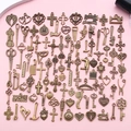 Flat lay of vintage bronze alloy DIY charms featuring assorted religious and craft motifs - Antique Bronze Mixed (SN1028)