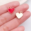Pink heart-shaped pendant with red enamel finish on fingertip for size reference - Red Heart Decor Style (11927)