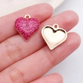 Pink glitter heart charm with gold base for DIY jewelry making displayed on a fingertip - Pink Glitter Heart Style (14323)