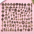 Antique bronze alloy pendants in musical and floral themes on a pink surface - Antique Bronze Mixed (SN1023)