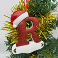 Sparkling red Christmas letter R ornament with Santa hat on a festive holiday tree - Letter R (Style R)