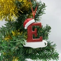 Christmas tree ornament featuring red glitter letter E with a festive Santa hat and ribbon - Letter E (Style E)