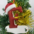 Christmas letter F ornament with red sequins and Santa hat hanging on a festive tree - Letter F (Style F)