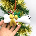 DIY bone-shaped Christmas tree ornament with golden bow and holly leaves for pets - Bowknot and Candy Cane Bone Style