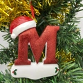 Christmas tree ornament featuring a glitter red letter M with festive Santa hat design - Letter M (Style M)