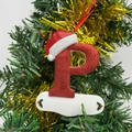 Sparkly red glitter Christmas letter P ornament with Santa hat hanging on a festive tree - Letter P (Style P)