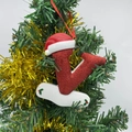Sparkly red Christmas letter V ornament with Santa hat on a festive tree branch - Letter V (Style V)