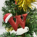 Christmas tree ornament featuring a red glitter capital letter W with a Santa hat and holly - Letter W (Style W)