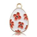 Macro shot of oval gold metal pendant with white enamel and red floral DIY design - Red Flower Egg